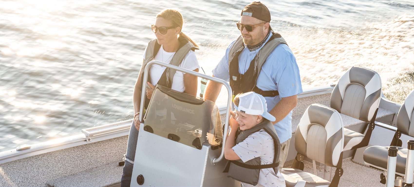 Family driving a pontoon boat